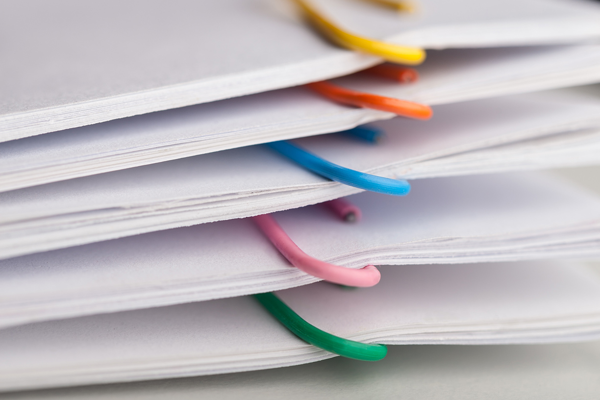 File folders with documents and bright paperclips
